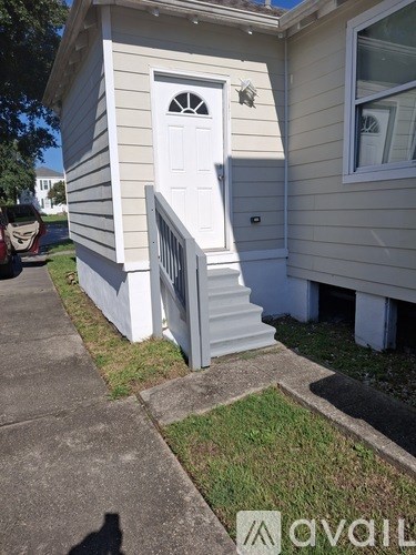 A small house with a white door and a window.