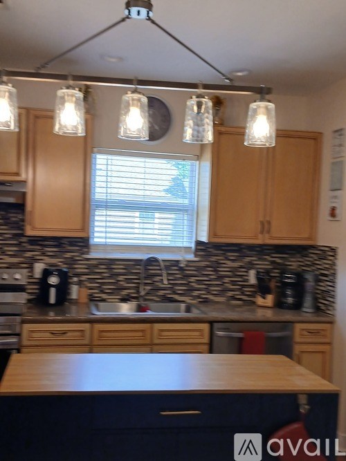 A kitchen with wooden cabinets and a black countertop.