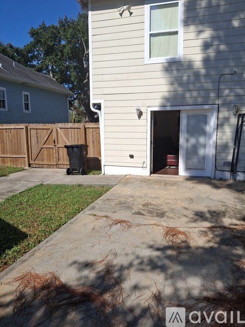 A house with a white door and a brown fence.