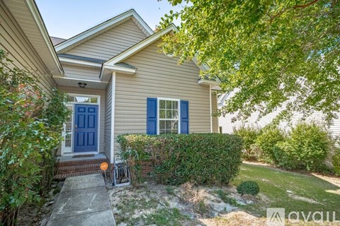 A house with a blue door and window is for sale.