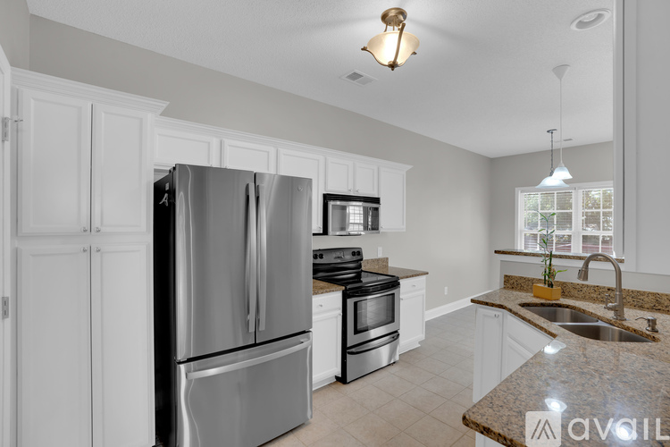 A kitchen with a stainless steel refrigerator and other appliances.