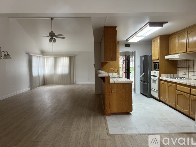 A spacious kitchen with wooden cabinets and a central island.