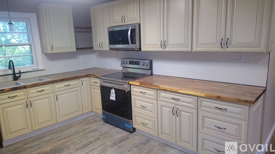 A kitchen with wooden cabinets and a black oven.