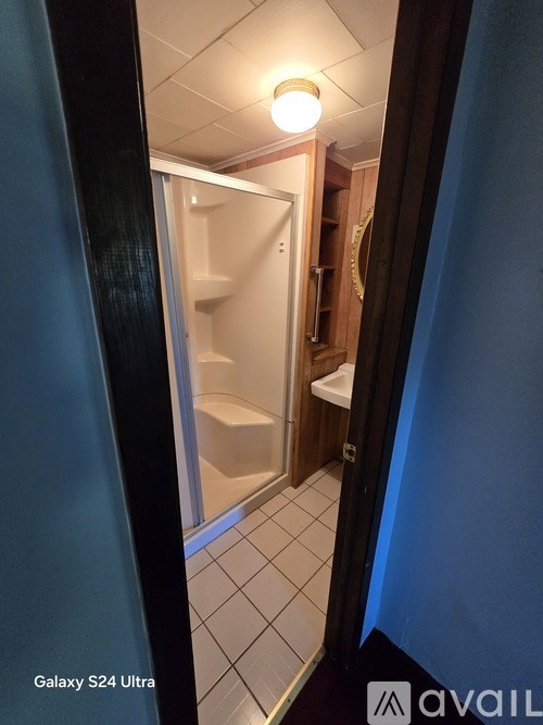 A room with blue walls and a ceiling fan.