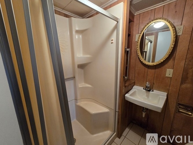 A bathroom with a sink, mirror and toilet.