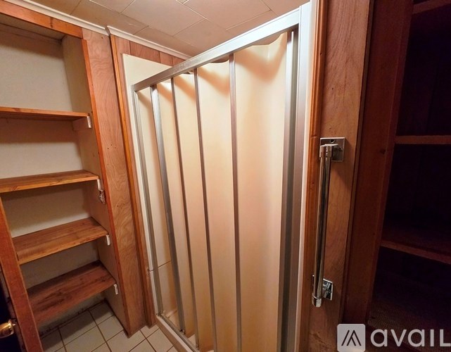 A wooden door with a glass panel and a handle.
