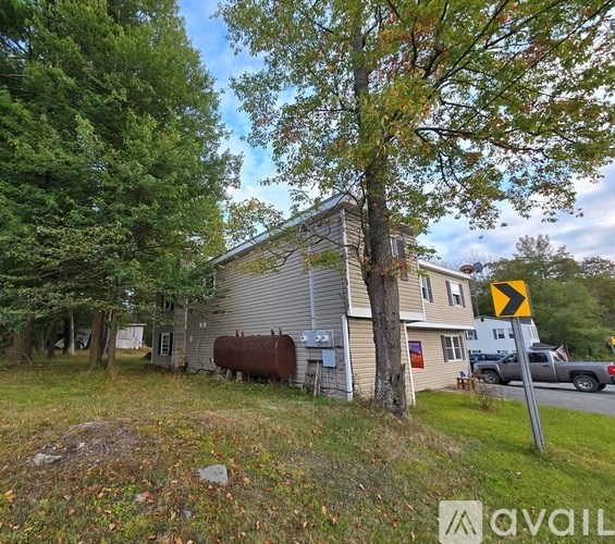 A house with a yellow sign in front of it.