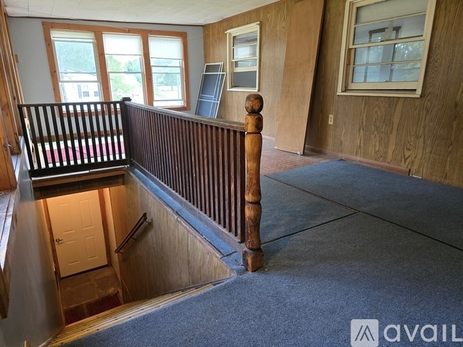 A room with wooden walls and a carpeted floor.