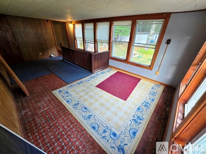 A room with a red and blue checkered floor mat in the middle.