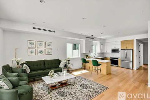 A modern living room with a green sofa and a coffee table.
