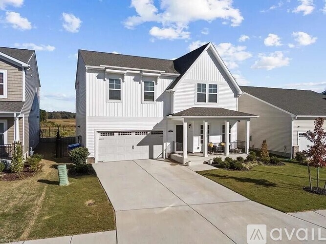 A large white house with a garage is available for sale.