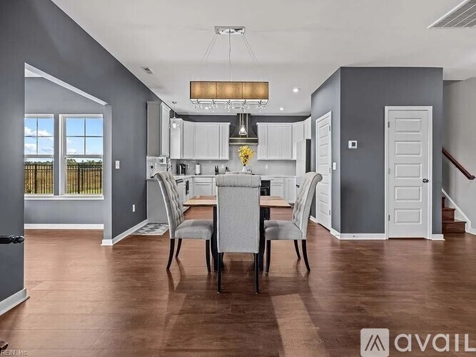 A modern kitchen with a dining table set for four.