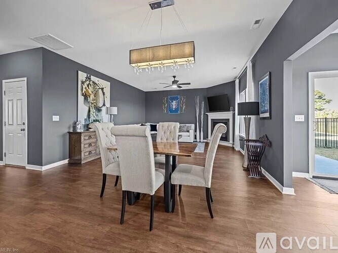 A dining room with a table set for four.