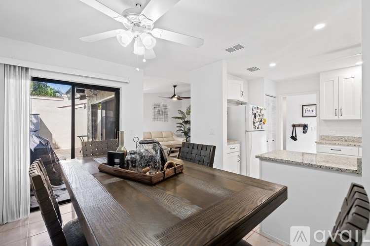 A modern dining room with a wooden table and chairs.