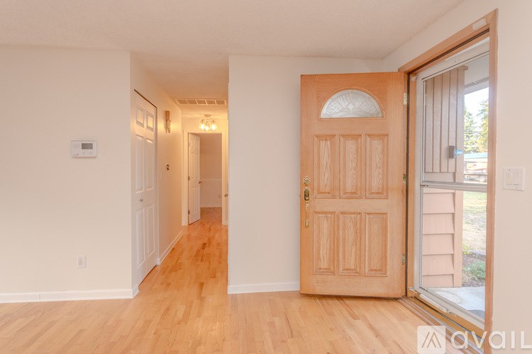 A room with a wooden floor and a wooden door.