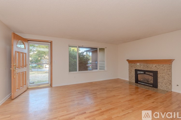 A room with a fireplace and wooden floors.
