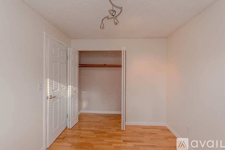 A room with a wooden floor and a white door.