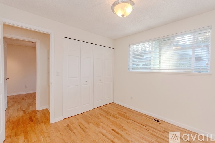 Empty room with wooden floor and white walls.
