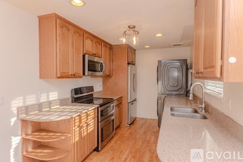 A kitchen with wooden cabinets and stainless steel appliances.