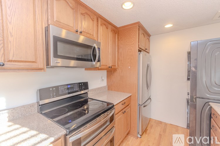 A kitchen with wooden cabinets and stainless steel appliances.