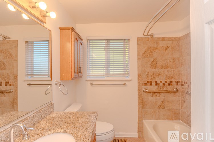 A bathroom with a toilet, sink, and shower.