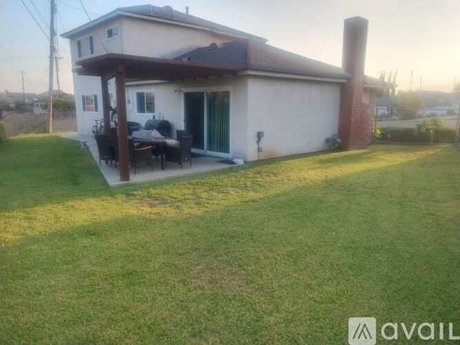 A house with a patio and a chimney is for sale.