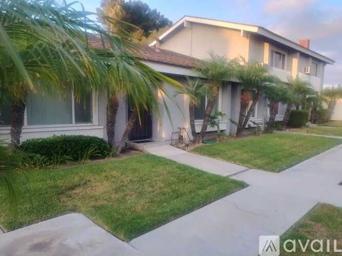 A house with a white fence and a green lawn.
