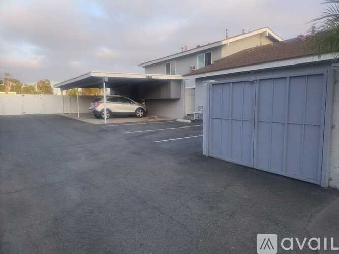 A car is parked in a garage attached to a house.