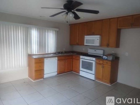 A kitchen with wooden cabinets and white appliances.