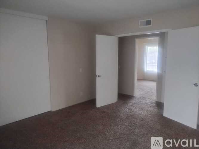 A room with carpeted floor and white walls.