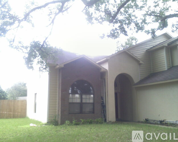 A house with a brown roof and a white garage door.