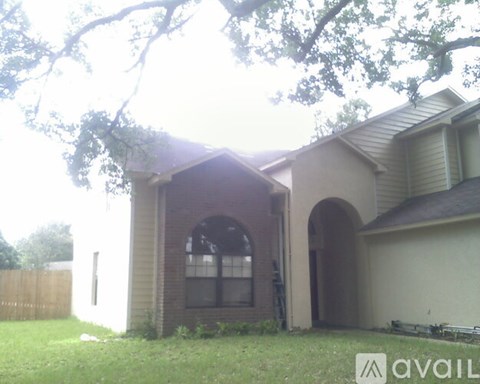 A house with a brown roof and a white garage door.