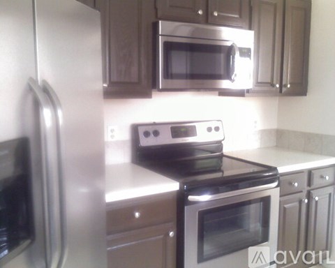 A kitchen with a stove top oven and microwave above it.