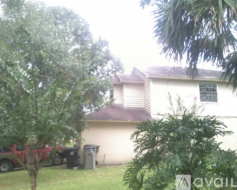 A house with a tree in front of it.