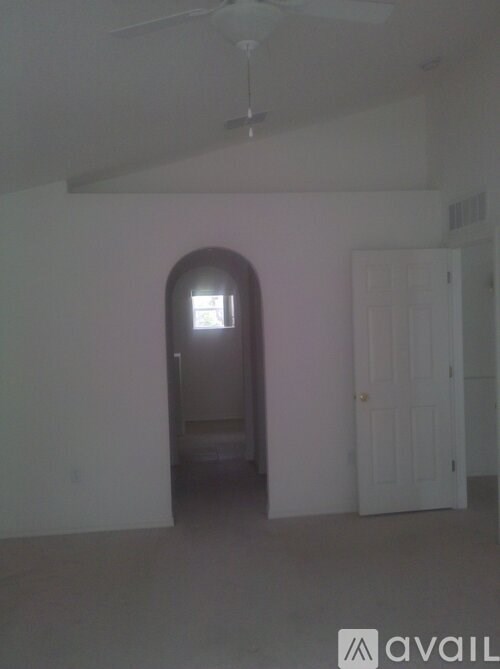 A room with a fan and a door.