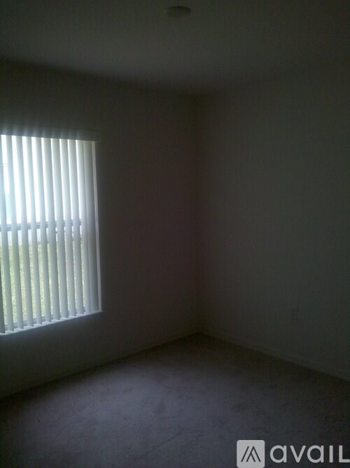 A room with a window and a wall.