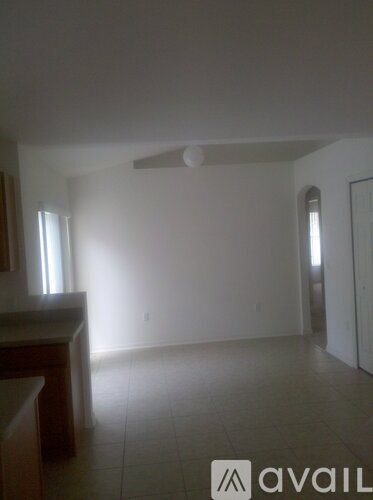 A room with a tiled floor and a ceiling fan.