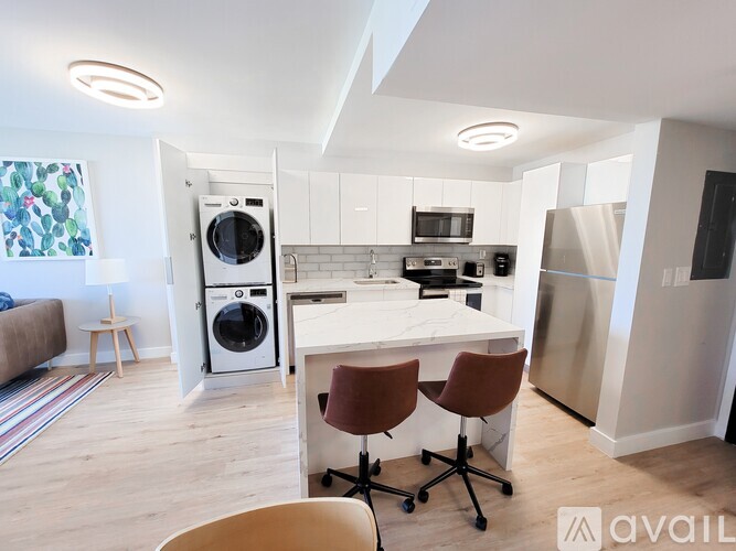 A kitchen with a white countertop and a refrigerator.