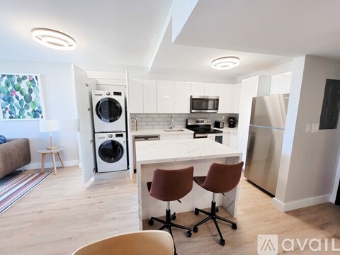 A kitchen with a white countertop and a refrigerator.