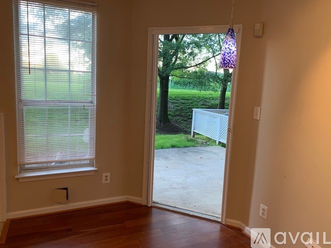 A room with a sliding glass door leading to a backyard.