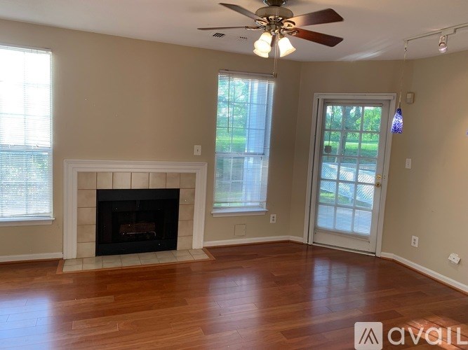 A room with a fireplace and a ceiling fan.