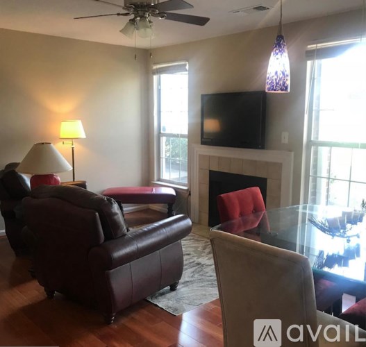 A living room with a fireplace and a television.