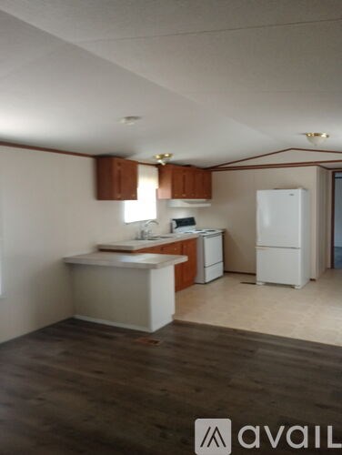 A kitchen with white appliances and wooden cabinets.