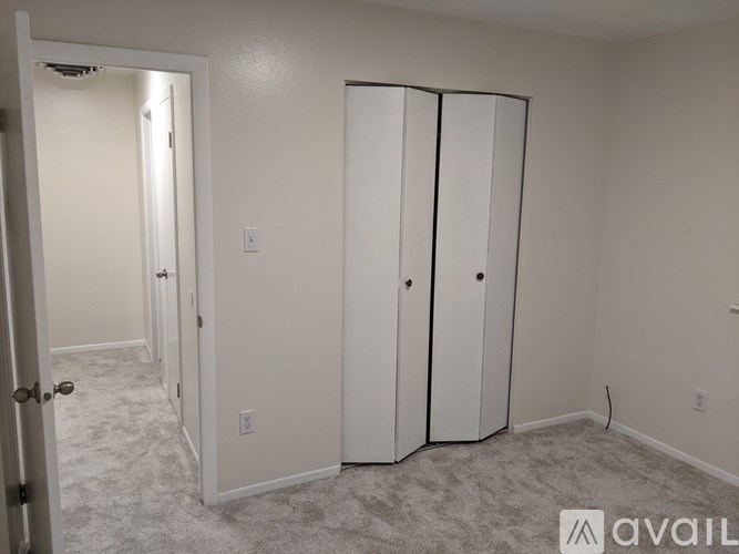 A room with a white door and a white wardrobe.
