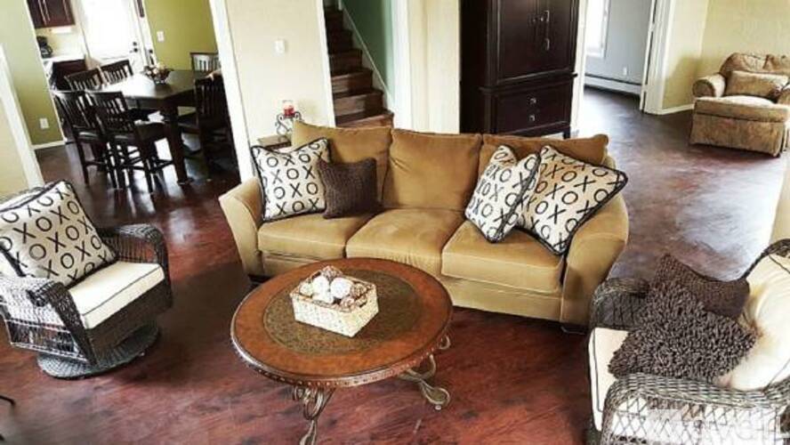 A living room with a brown couch and a coffee table.
