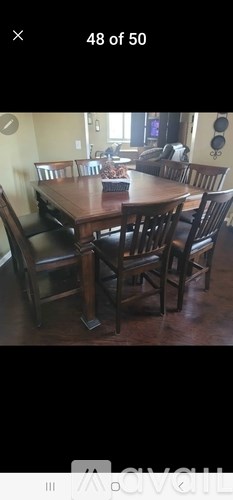 A dining room with a wooden table and chairs.