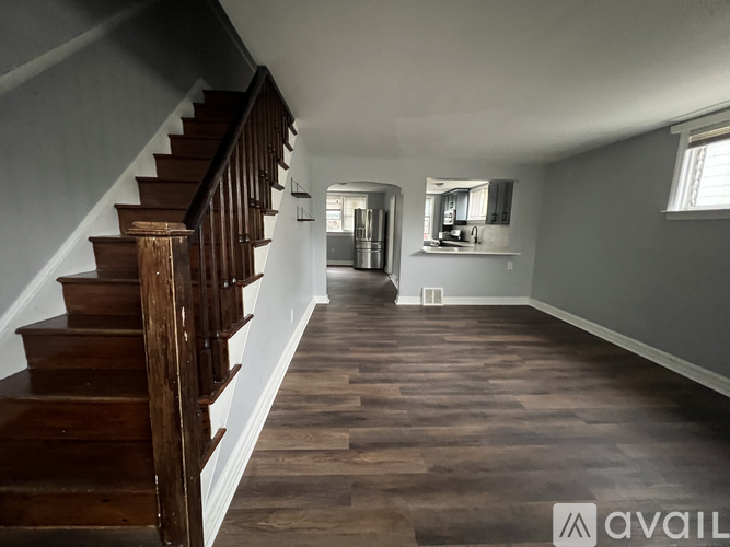 A wooden staircase leads up to a second floor.