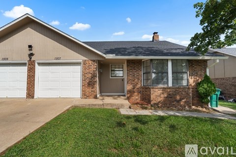 A house with a garage and a driveway in front.