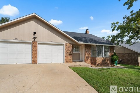 A house with a garage and a driveway is for sale.