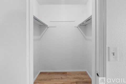 Empty white hallway with a door on the right.